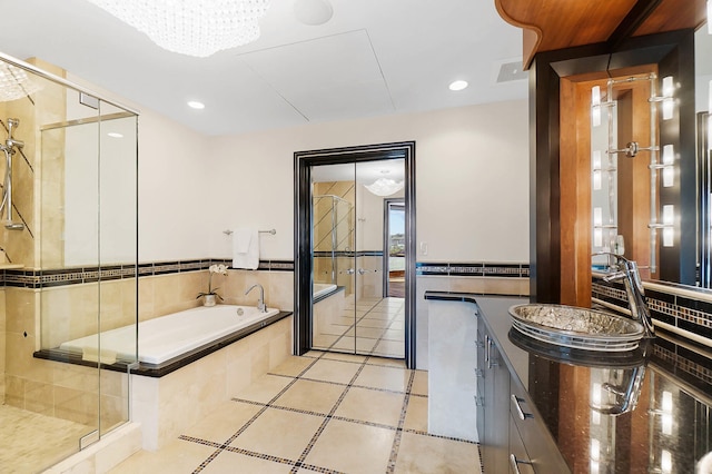 bathroom featuring a garden tub, recessed lighting, a sink, tile patterned floors, and a stall shower