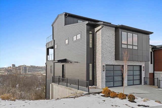 view of property exterior with driveway and an attached garage