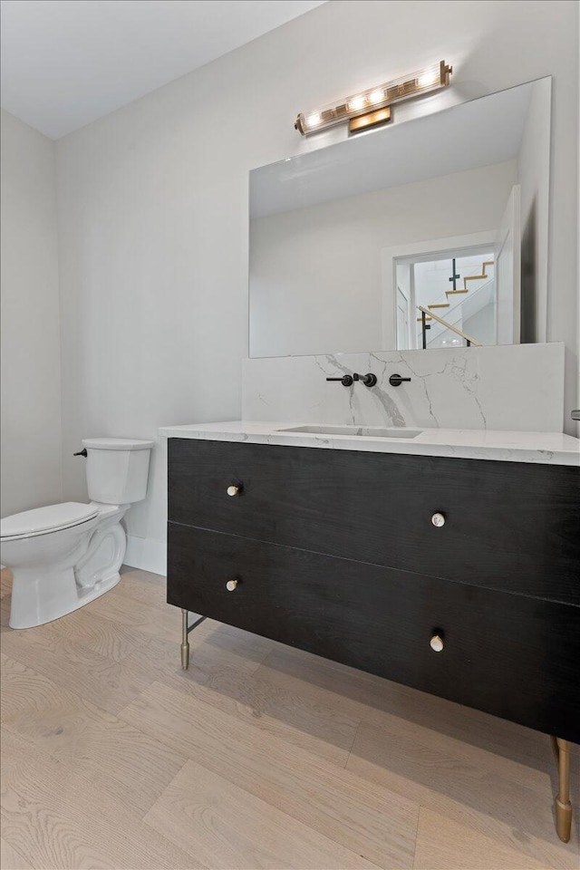 bathroom featuring toilet and vanity