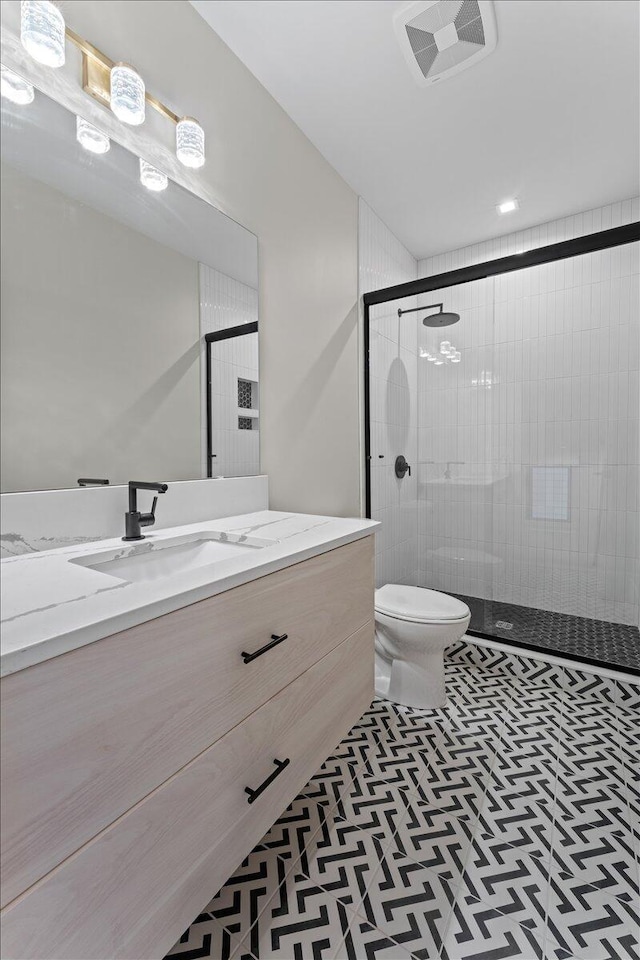 full bathroom with tile patterned flooring, toilet, visible vents, vanity, and a stall shower