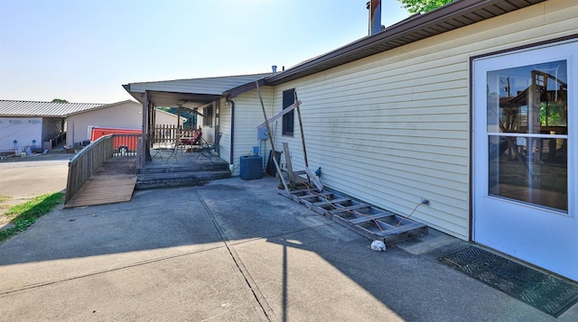 view of side of property with a deck and central air condition unit