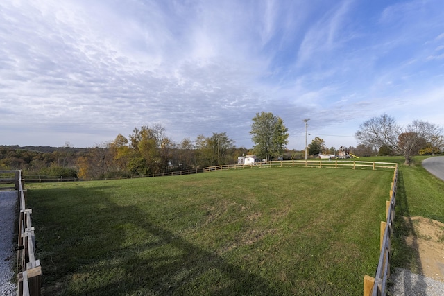 view of yard with a rural view and fence