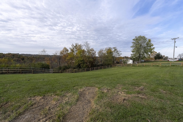 view of yard featuring a rural view and fence