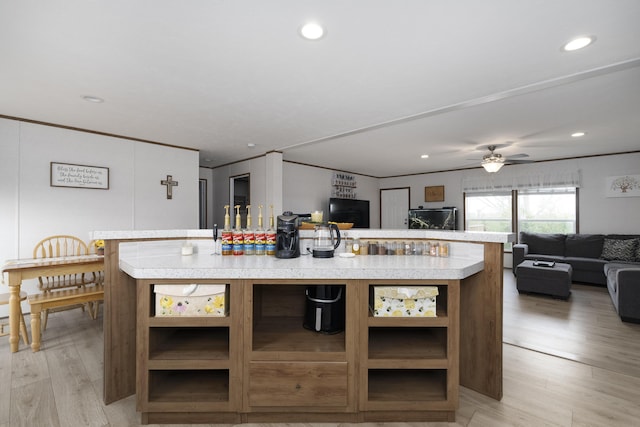 kitchen featuring open floor plan, light countertops, and open shelves