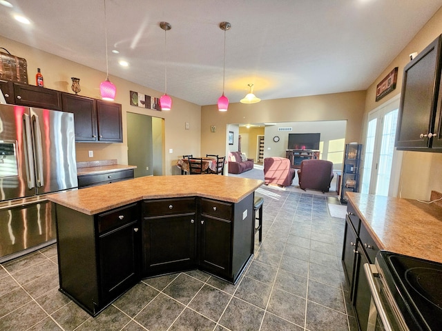 kitchen featuring stainless steel appliances, a kitchen island, light countertops, and decorative light fixtures