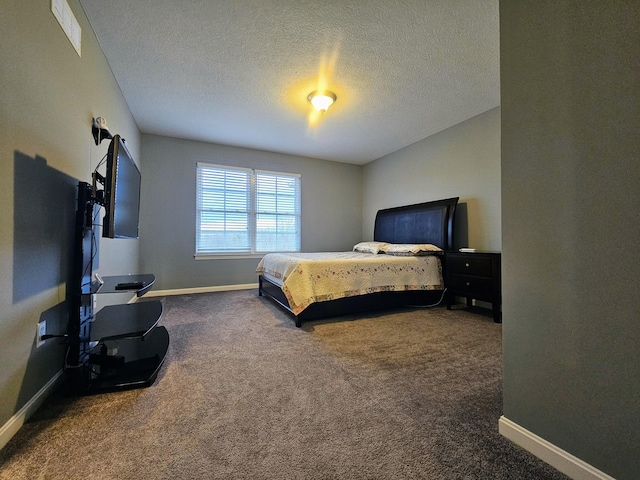 bedroom with carpet, a textured ceiling, and baseboards