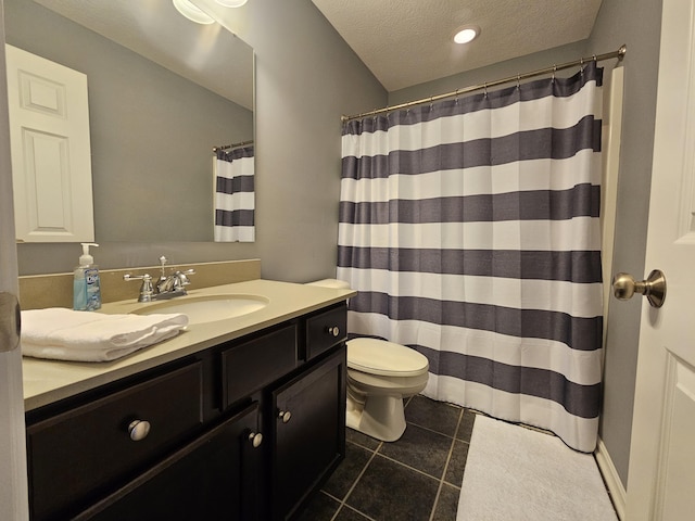 bathroom featuring toilet, a textured ceiling, vanity, a shower with curtain, and tile patterned floors