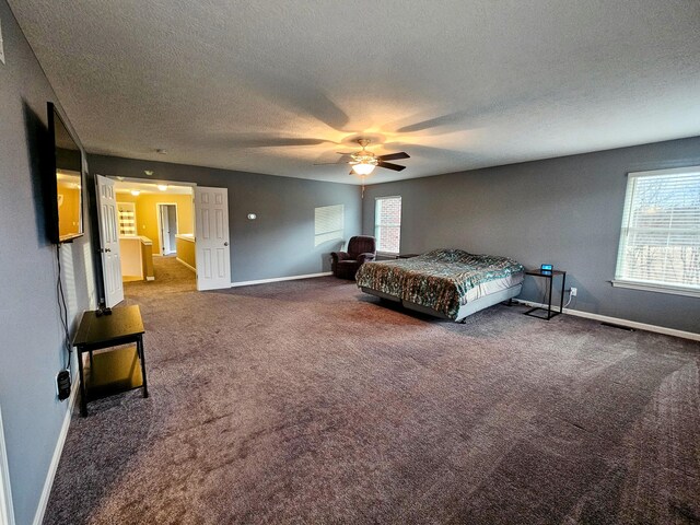 unfurnished bedroom featuring carpet floors, a ceiling fan, baseboards, and a textured ceiling