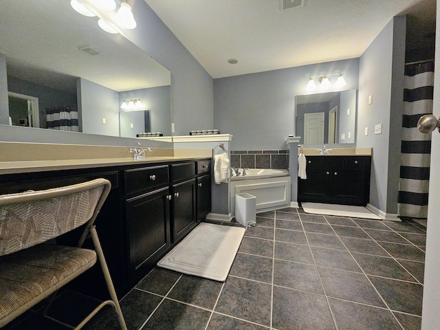 full bathroom featuring two vanities, tile patterned flooring, visible vents, and a sink