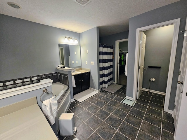 full bathroom with tile patterned floors, visible vents, a textured ceiling, vanity, and a bath