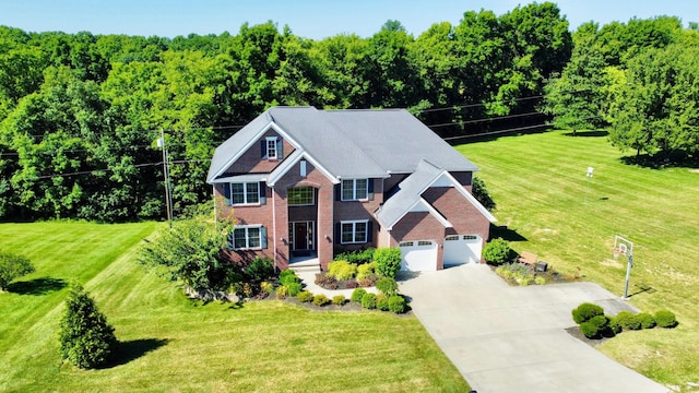 view of front of home featuring a garage, driveway, brick siding, and a front yard