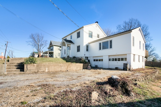 view of side of home featuring a garage and driveway