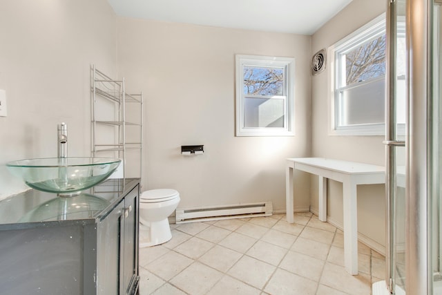 bathroom with a baseboard radiator, vanity, toilet, and tile patterned floors