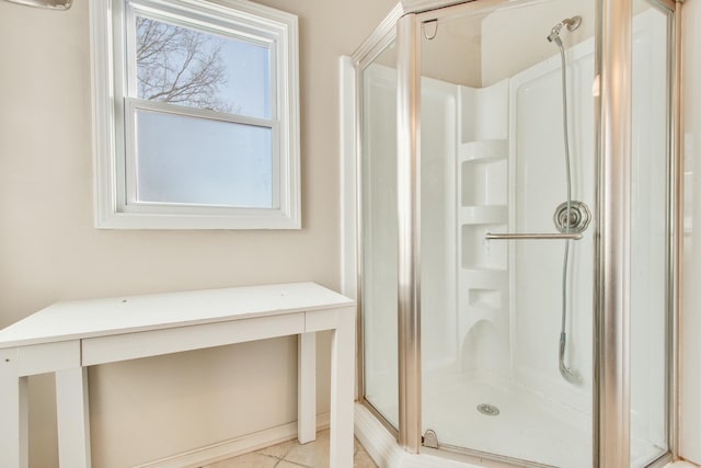 full bathroom featuring a stall shower and tile patterned flooring