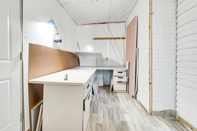 kitchen featuring open shelves, light countertops, and light wood-style floors