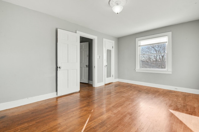 unfurnished bedroom with wood-type flooring and baseboards