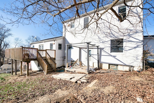 back of property with a deck and stairs