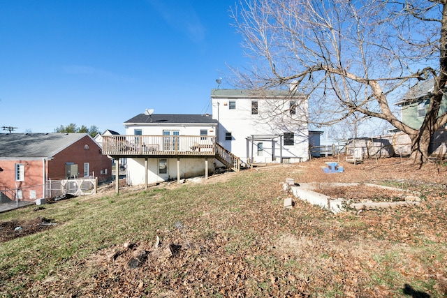 back of house featuring a yard, stairs, fence, and a wooden deck