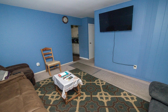 carpeted living room featuring baseboards