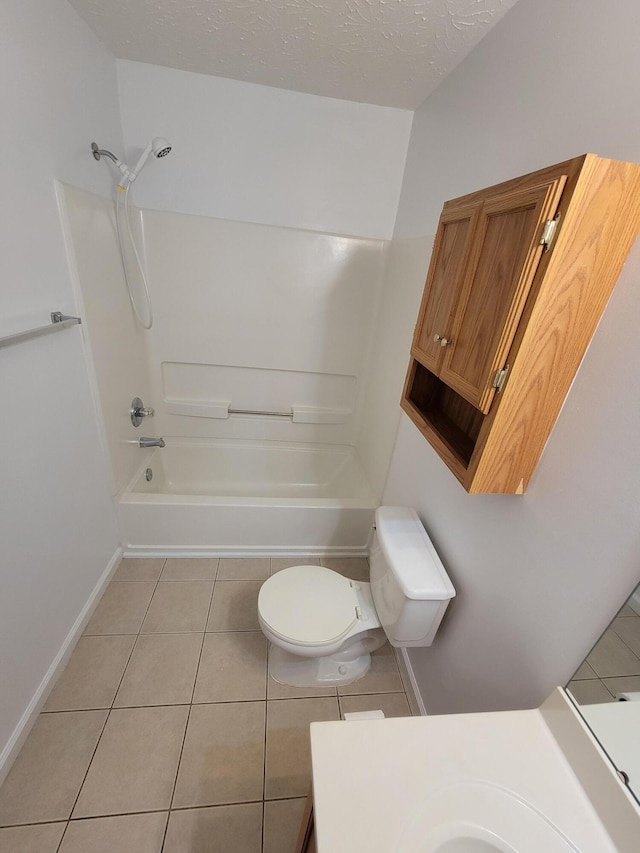 full bath featuring a textured ceiling, shower / tub combination, toilet, vanity, and tile patterned floors