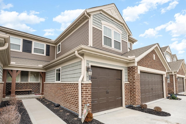 view of front of property featuring concrete driveway and brick siding