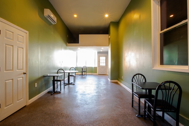 interior space featuring recessed lighting, a wall unit AC, and baseboards