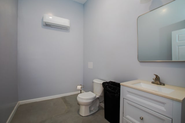 bathroom with baseboards, toilet, an AC wall unit, vanity, and concrete floors