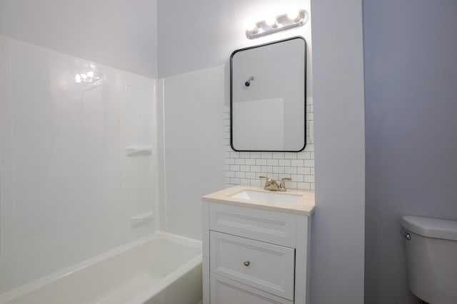 full bathroom with washtub / shower combination, toilet, vanity, and decorative backsplash