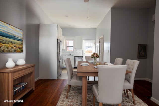 dining area featuring dark wood-style floors and baseboards