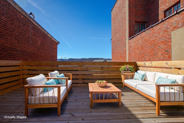 wooden terrace with an outdoor hangout area
