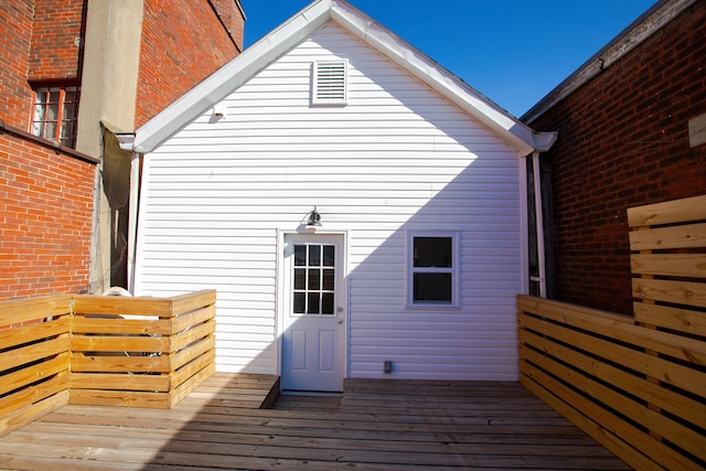 back of property featuring a wooden deck
