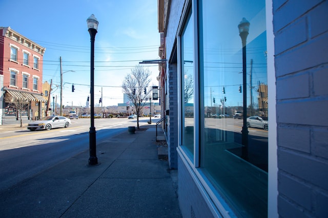 view of street featuring sidewalks, street lighting, and curbs