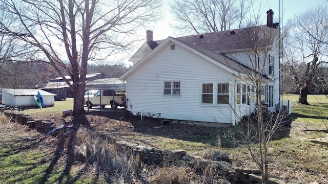 view of side of home with a chimney