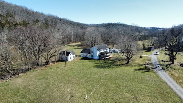 aerial view featuring a view of trees and a rural view