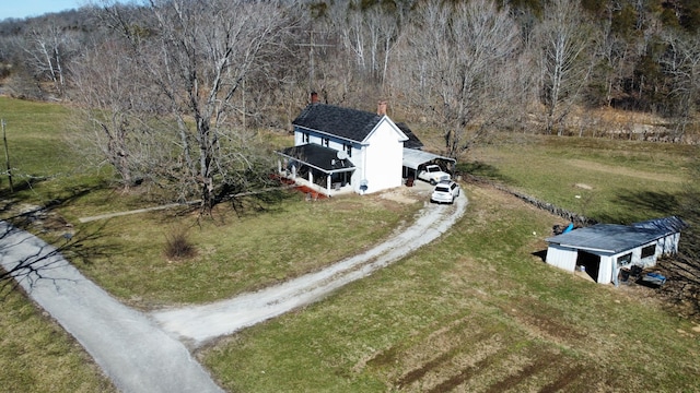 drone / aerial view with a wooded view