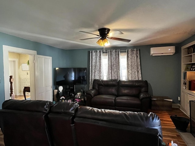 living area featuring ceiling fan, an AC wall unit, and wood finished floors