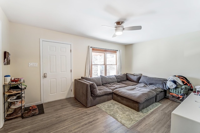 living area featuring a ceiling fan and wood finished floors