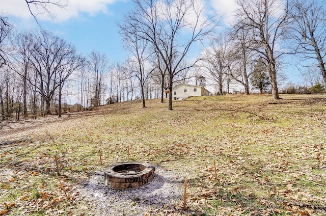 view of yard featuring an outdoor fire pit