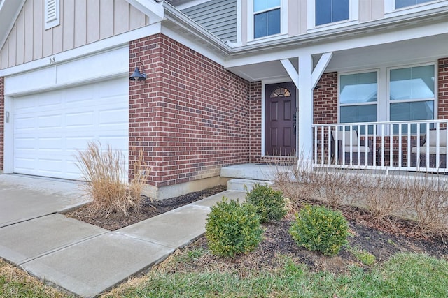 entrance to property featuring brick siding, board and batten siding, and an attached garage