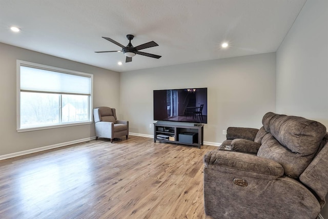 living room featuring light wood finished floors, baseboards, a ceiling fan, and recessed lighting