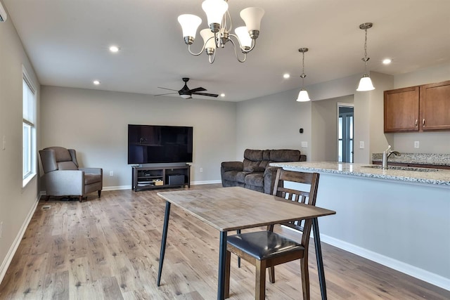 dining room featuring light wood finished floors, ceiling fan, baseboards, and recessed lighting