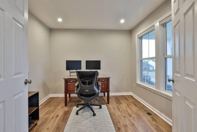 office space with recessed lighting, visible vents, light wood-style flooring, and baseboards