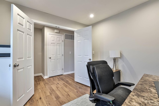 office area with light wood-style flooring, visible vents, baseboards, and recessed lighting