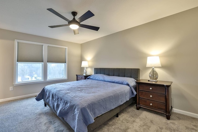 carpeted bedroom featuring baseboards and a ceiling fan