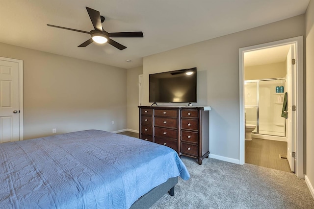 bedroom with a ceiling fan, connected bathroom, baseboards, and carpet flooring