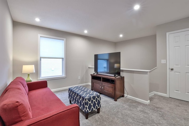 living room with recessed lighting, light carpet, and baseboards