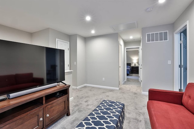 living area with recessed lighting, light colored carpet, visible vents, baseboards, and attic access