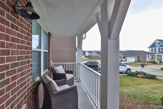 balcony with covered porch and a residential view