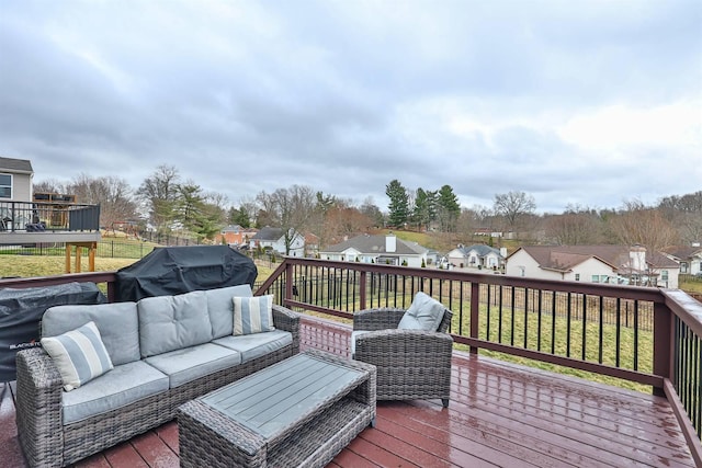 wooden terrace featuring an outdoor hangout area and a residential view