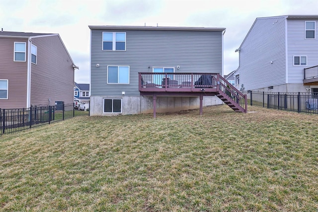 back of property with a deck, a lawn, a fenced backyard, and stairs